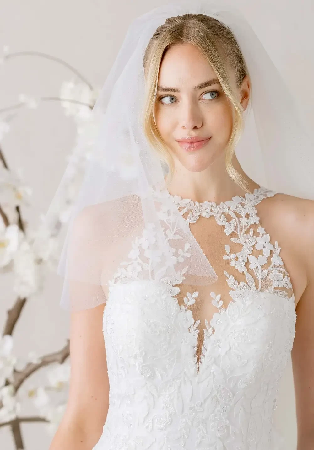 model is wearing a lace bridal gown