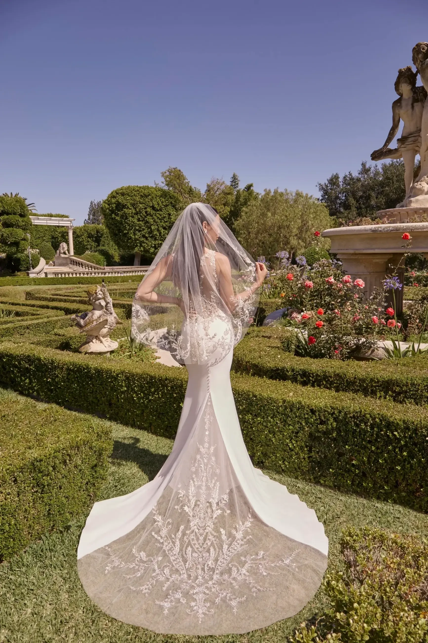 model is wearing a sleek fit and flare bridal gown
