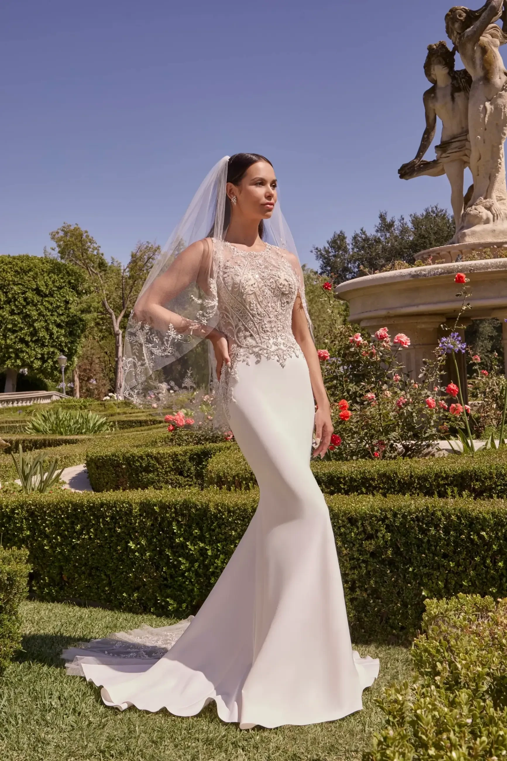 model is wearing a sleek fit and flare bridal gown