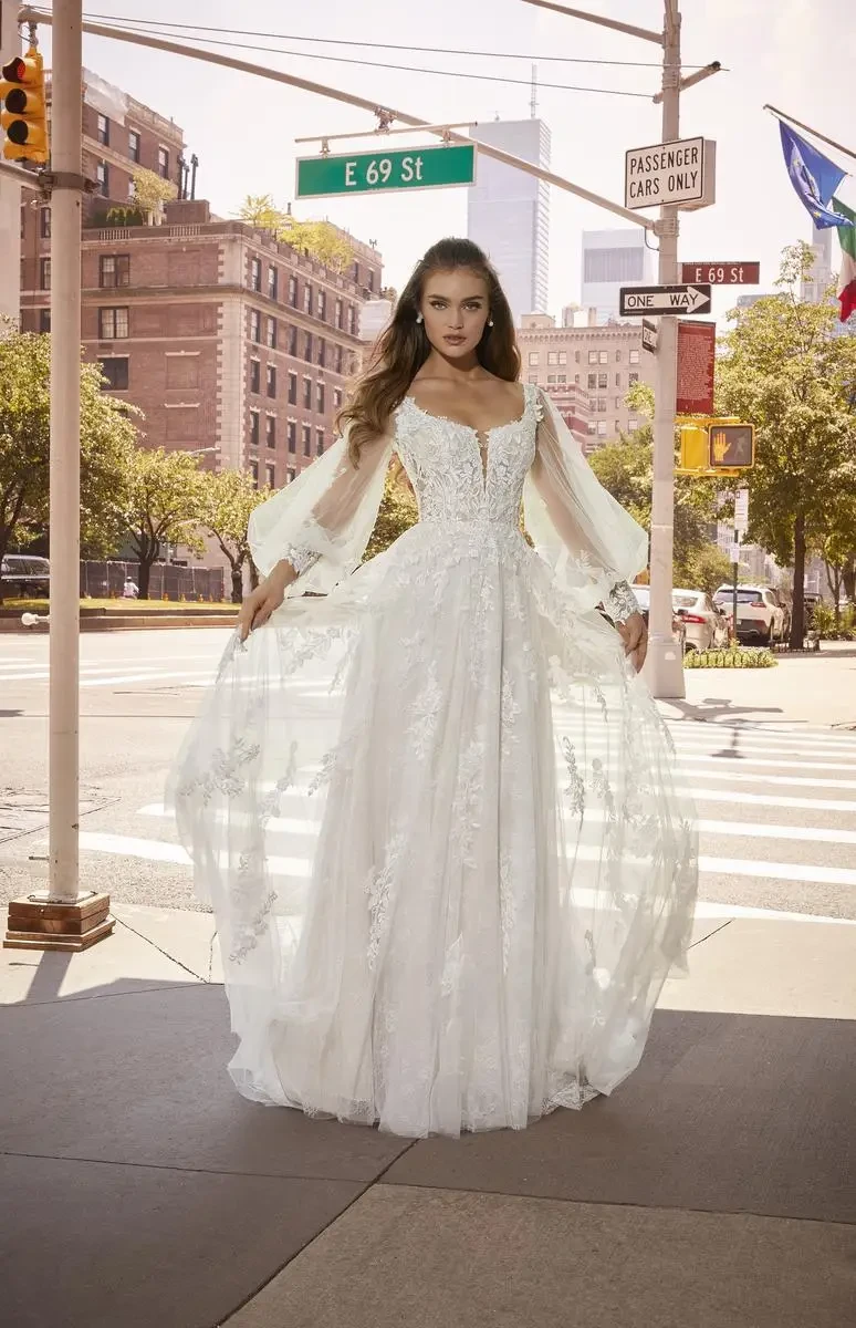 model is wearing an a-line wedding dress with bishop sleeves