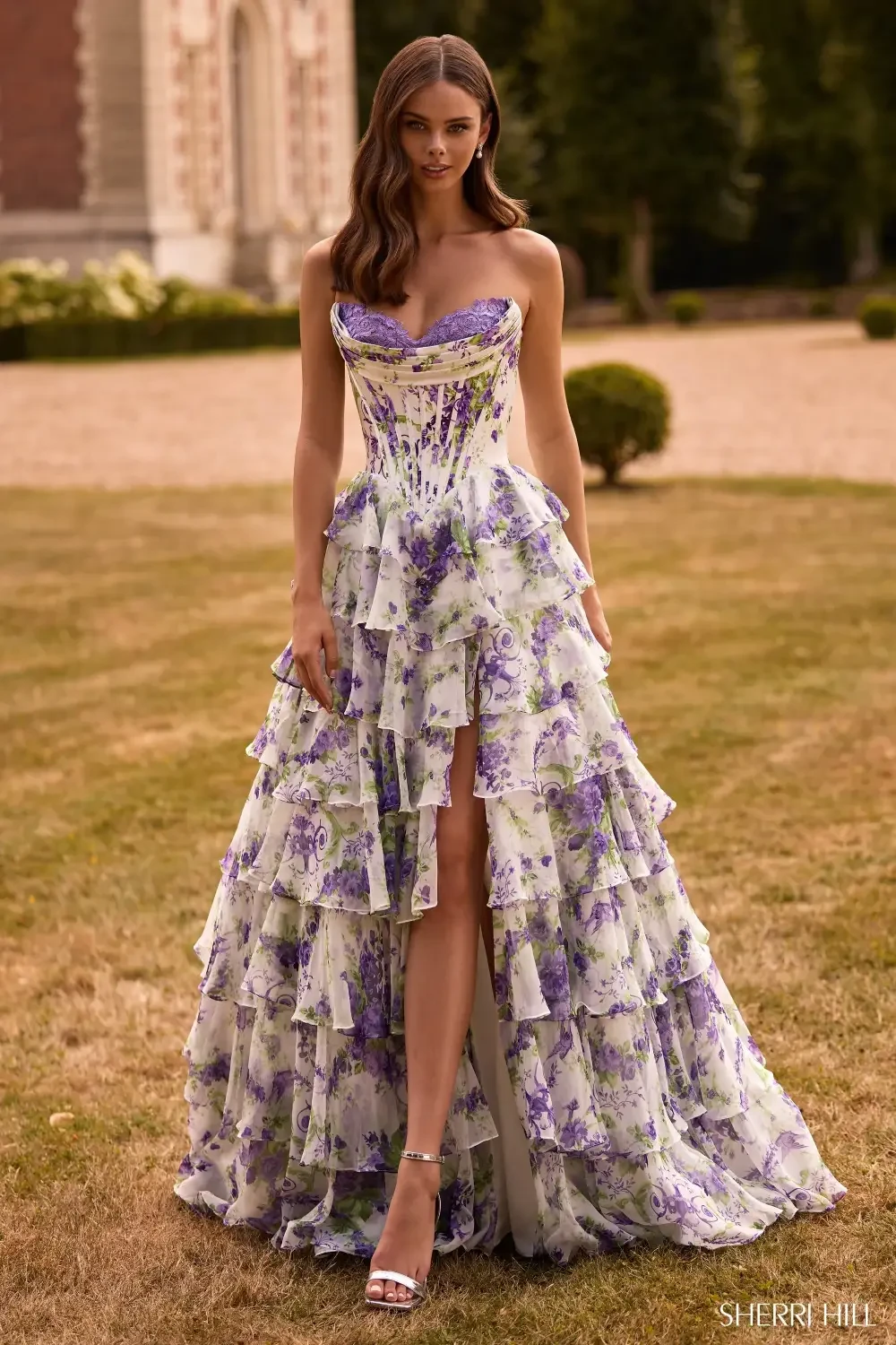 model is wearing a purple floral prom dress