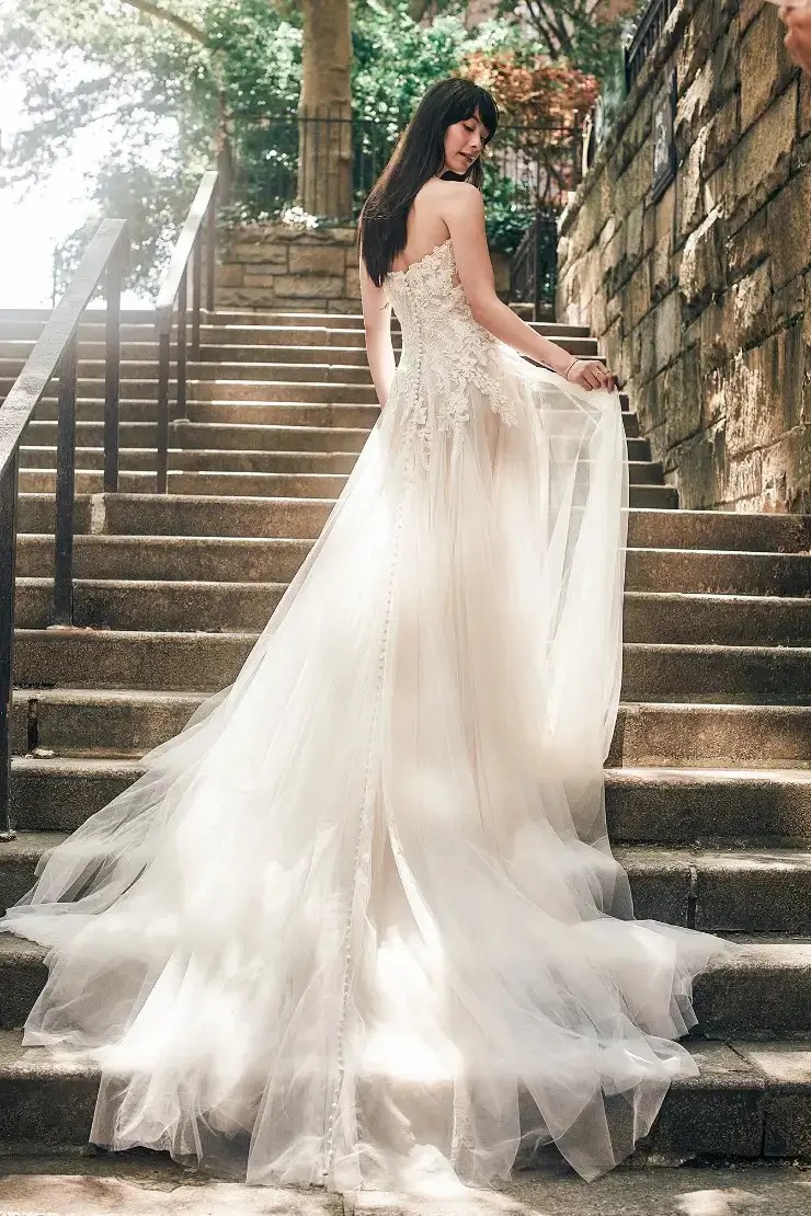 Model is wearing a basque drop waist wedding dress by allure bridals