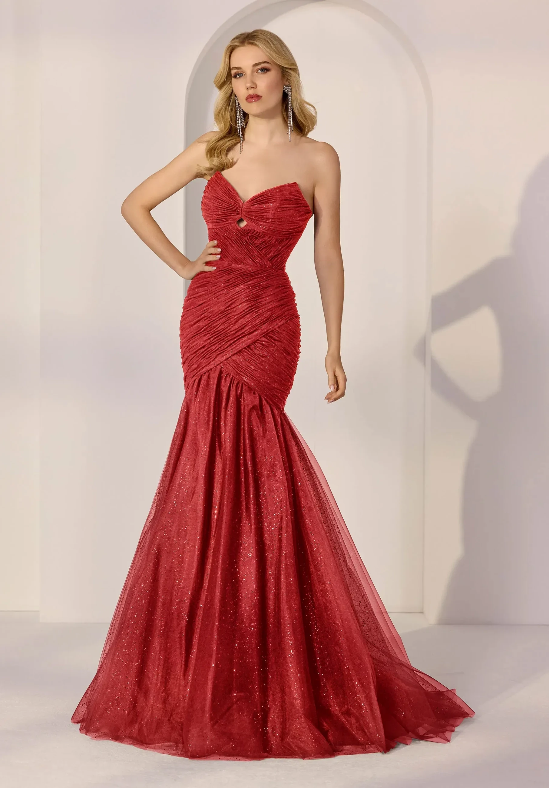 Model wearing a red prom gown.