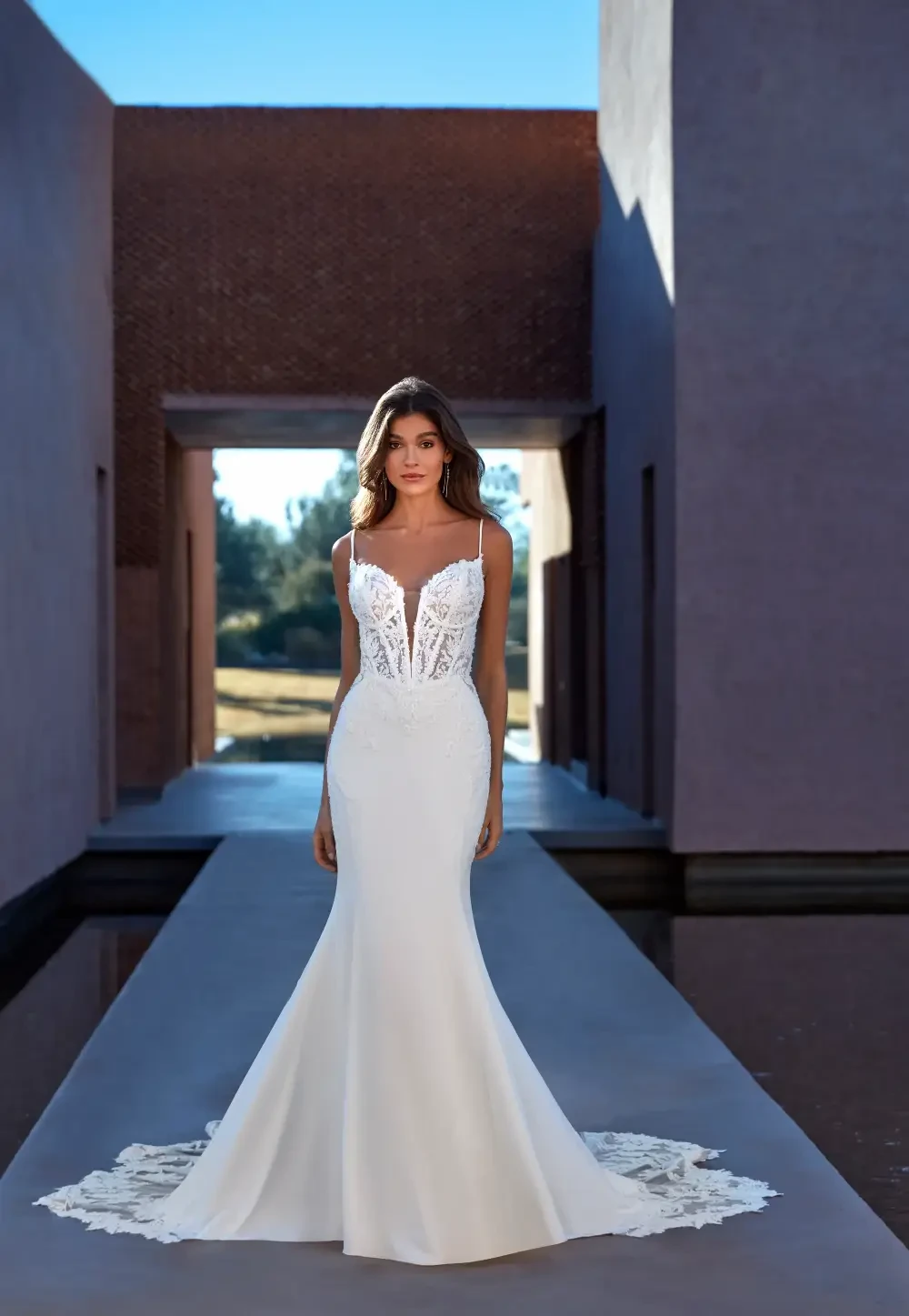 model is wearing a strapless fit and flare bridal gown